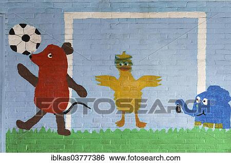 "Mouse figure playing football with its friends, mural in a school playground, Germany, Europe" View Large Photo Image Stock Photograph - "Mouse figure playing football with its friends, mural in a school playground, Germany, Europe". Fotosearch