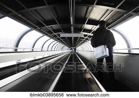 "Moving sidewalk in oval tunnel connecting exhibition halls on fair ground, Dusseldorf, Rhineland, North Rhine-Westphalia, Germany, Europe" View Large Photo Image Stock Photo - "Moving sidewalk in oval tunnel connecting exhibition halls on fair ground, Dusseldorf, Rhineland, North Rhine-Westphalia, Germany, Europe". Fotosearch