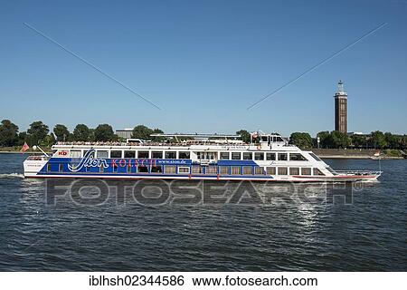 "MS Drachenfels, a Sion party and disco boat of KD near Cologne floating on the Rhine river, the historic heritage-protected Messeturm tower at the back, Cologne, North Rhine-Westphalia, Germany, Europe" View Large Photo Image Stock Photograph - "MS Drachenfels, a Sion party and disco boat of KD near Cologne floating on the Rhine river, the historic heritage-protected Messeturm tower at the back, Cologne, North Rhine-Westphalia, Germany, Europe". Fotosearch