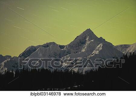 "Mt. Gilbert, 9, 035 foot, in the Chugach Range, lit by the glow of the northern lights, aurora borealis in the north and a new moon in the west, Harriman Fjord, Prince William Sound, Anchorage, Alaska, United States, North America" View Large Photo Image Stock Photo - "Mt. Gilbert, 9, 035 foot, in the Chugach Range, lit by the glow of the northern lights, aurora borealis in the north and a new moon in the west, Harriman Fjord, Prince William Sound, Anchorage, Alaska, United States, North America". Fotosearch