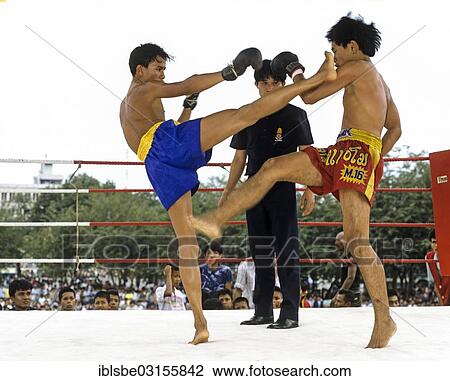 Stock Image - "Muay Thai, Thai boxing, two men fighting in a boxing ring, Bangkok, Central Thailand, Thailand, Asia". Fotosearch