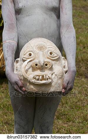 "Mudman carrying a mask in his hands during the traditional Sing Sing in the highlands, Paya, Highlands, Papua New Guinea, Oceania" View Large Photo Image Stock Image - "Mudman carrying a mask in his hands during the traditional Sing Sing in the highlands, Paya, Highlands, Papua New Guinea, Oceania". Fotosearch
