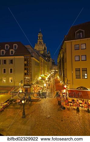 Stock Image - "Muenzgasse"""", little street with restaurants leading towards """"Neumarkt"""", the dome of the church """"Frauenkirche"""" in the back. Dresden, Germany, Europe". Fotosearch
