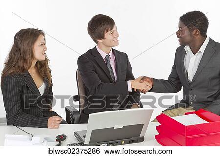 Stock Photograph - Multi-ethnic people in an office. Fotosearch