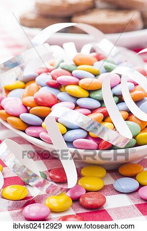Multicolored candy with paper streamer View Large Photo Image Stock Photo - Multicolored candy with paper streamer. Fotosearch