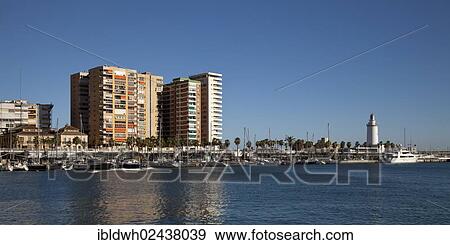 Stock Photo - "Multistorey buildings and the lighthouse at the harbour, Malaga, Costa del Sol, Andalusia, Spain, Europe, PublicGround, Europe". Fotosearch