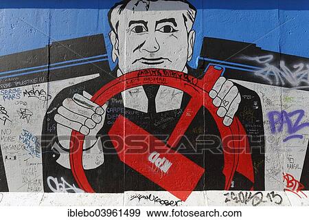 Stock Photo - "Mural, Gorbachev sitting behind the wheel with the communist hammer symbol, painting on a remaining piece est of the Berlin Wall, East Side Gallery, Berlin-Friedrichshain, Berlin, Germany, Europe". Fotosearch