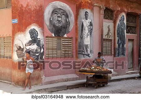 Stock Photo - "Murals and a stand with vegetables in the historic town centre, Havana, Cuba, North America". Fotosearch