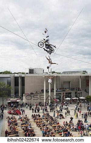Museum Mile Festival, high-wire artist Falko Traber riding a motorbike on the tightrope, audience below, Bonn, North Rhine-Westphalia, Germany, Europe View Large Photo Image Picture - Museum Mile Festival, high-wire artist Falko Traber riding a motorbike on the tightrope, audience below, Bonn, North Rhine-Westphalia, Germany, Europe. Fotosearch