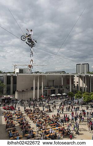Museum Mile Festival, high-wire artist Falko Traber riding a motorbike on the tightrope, audience below, Bonn, North Rhine-Westphalia, Germany, Europe View Large Photo Image Stock Image - Museum Mile Festival, high-wire artist Falko Traber riding a motorbike on the tightrope, audience below, Bonn, North Rhine-Westphalia, Germany, Europe. Fotosearch