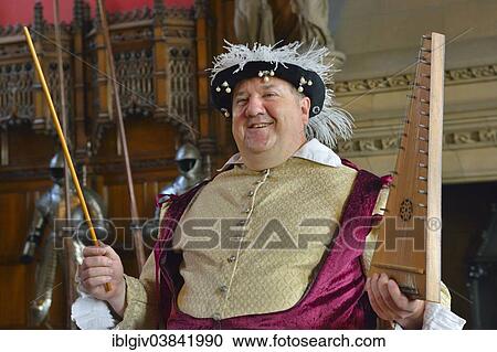 Stock Image - "Musician in period costume performing on a medieval psaltery, Edinburgh Castle, Edinburgh, Scotland, United Kingdom, Europe". Fotosearch