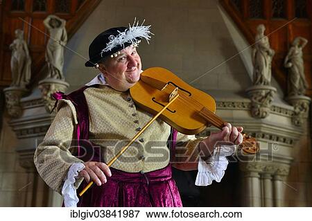 Stock Photo - "Musician in period costume performing on a medieval fiddle, Edinburgh Castle, Edinburgh, Scotland, United Kingdom, Europe". Fotosearch