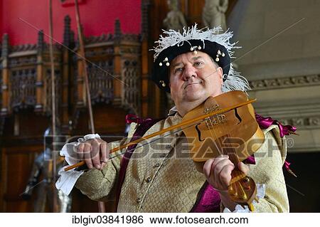 Stock Photograph - "Musician in period costume performing on a medieval fiddle, Edinburgh Castle, Edinburgh, Scotland, United Kingdom, Europe". Fotosearch