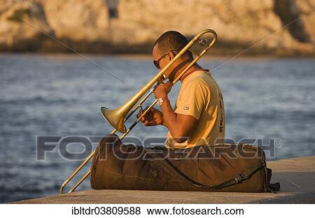 "Musician playing the trombone at the Malecon esplanade, Havana, Cuba, North America" View Large Photo Image Stock Photo - "Musician playing the trombone at the Malecon esplanade, Havana, Cuba, North America". Fotosearch