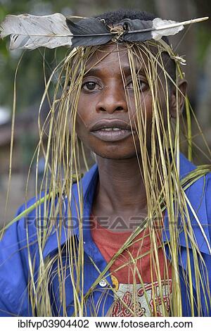 "Musician with a headdress made of bast and a feather, Nkala, Bandundu Province, Democratic Republic of the Congo" View Large Photo Image Stock Image - "Musician with a headdress made of bast and a feather, Nkala, Bandundu Province, Democratic Republic of the Congo". Fotosearch