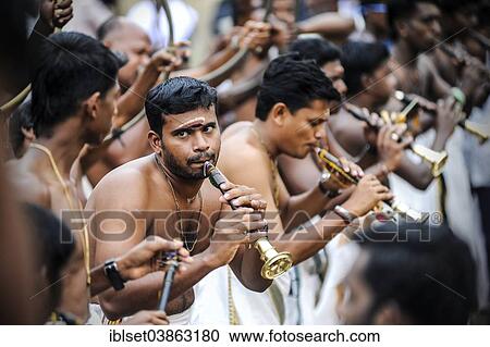 Stock Image - "Musicians with trumpets at Hindu temple festival, Thrissur, Kerala, South India, India, Asia". Fotosearch