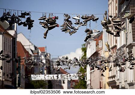 "Mysterious hanging shoes in the Flensburg Norderstrasse, Flensburg, Schleswig-Holstein, Germany, Europe" View Large Photo Image Stock Photograph - "Mysterious hanging shoes in the Flensburg Norderstrasse, Flensburg, Schleswig-Holstein, Germany, Europe". Fotosearch