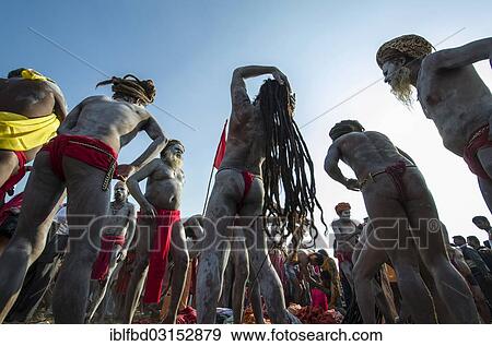 "Naga sadhus, holy men, smearing ashes onto their bodies and into their hair after Shahi Snan, the royal bath, during Kumbha Mela festival, Allahabad, Uttar Pradesh, India, Asia" View Large Photo Image Stock Photo - "Naga sadhus, holy men, smearing ashes onto their bodies and into their hair after Shahi Snan, the royal bath, during Kumbha Mela festival, Allahabad, Uttar Pradesh, India, Asia". Fotosearch