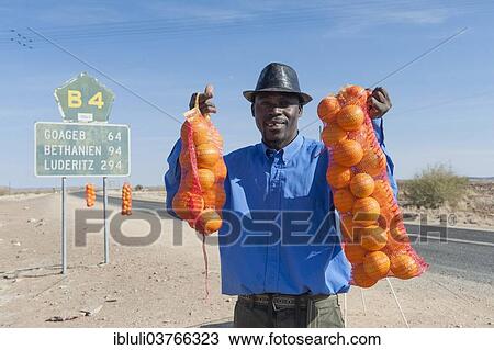 "Namibian man selling oranges along the B4 road, Namibia, Africa" View Large Photo Image Stock Image - "Namibian man selling oranges along the B4 road, Namibia, Africa". Fotosearch