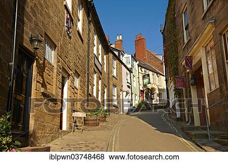 Stock Photo - "Narrow street of the historic fishing village of Robin Hood's Bay, North Yorkshire, England, United Kingdom, Europe". Fotosearch
