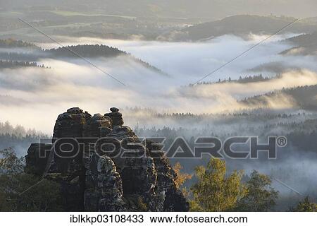 Stock Image - "Nasser Grund with morning fog, Saxon Switzerland, Bad Schandau, Saxon Switzerland region, Saxony, Germany, Europe". Fotosearch