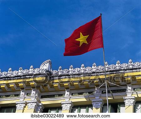 Stock Photo - "National flag flying at the main post office in Saigon or Ho Chi Minh City, Saigon, Ho-Chi-Minh-Stadt, Sudvietnam, Vietnam, Asia". Fotosearch