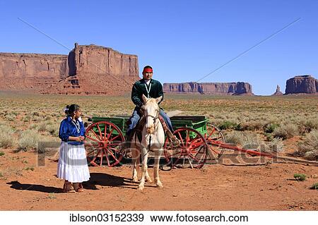 "Navajo Indians, man and woman with a horse in front of a carriage, Monument Valley, Utah, United States, North America" View Large Photo Image Stock Photo - "Navajo Indians, man and woman with a horse in front of a carriage, Monument Valley, Utah, United States, North America". Fotosearch