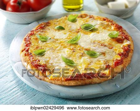Stock Photograph - "Neapolitan pizza, Pizza Margherita topped with 3 cheeses and basil". Fotosearch