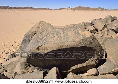 "Neolithic rock art, Bubaline or Bubalus period, rock engraving of a spiral symbol, Tassili n'Ajjer National Park, Unesco World Heritage Site, Sahara desert, Algeria, Africa" View Large Photo Image Picture - "Neolithic rock art, Bubaline or Bubalus period, rock engraving of a spiral symbol, Tassili n'Ajjer National Park, Unesco World Heritage Site, Sahara desert, Algeria, Africa". Fotosearch