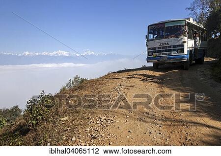 "Nepalese bus travelling on a gravel road, near Dhulikel, mountains of the Himalayas at the back, Nepal, Asia" View Large Photo Image Stock Image - "Nepalese bus travelling on a gravel road, near Dhulikel, mountains of the Himalayas at the back, Nepal, Asia". Fotosearch