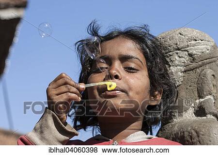 "Nepalese girl making soap bubbles, Durbar Square, Patan, Nepal, Asia" View Large Photo Image Stock Photo - "Nepalese girl making soap bubbles, Durbar Square, Patan, Nepal, Asia". Fotosearch