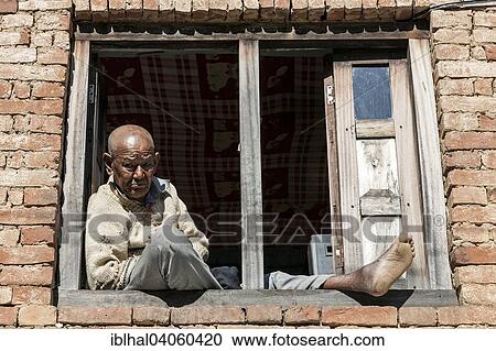 "Nepalese man sitting at the window, at Nargakot, Nepal, Asia" View Large Photo Image Stock Image - "Nepalese man sitting at the window, at Nargakot, Nepal, Asia". Fotosearch
