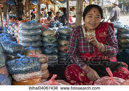 Stock Photo - "Nepalese woman at a market stall selling pulses, Patauri, Nepal, Asia". Fotosearch