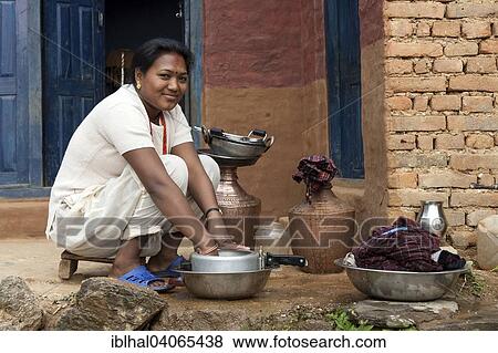 "Nepalese woman doing the dishes, Bandipur, Nepal, Asia" View Large Photo Image Stock Photo - "Nepalese woman doing the dishes, Bandipur, Nepal, Asia". Fotosearch