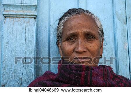 Stock Photo - "Nepalese woman in front of a blue door, portrait, Patan, Nepal, Asia". Fotosearch