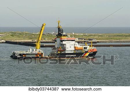 Stock Photo - "Neuwerk, a multi-purpose ship of the Federal Waterways and Shipping Administration, in front of Heligoland Dune, Helgoland, Schleswig-Holstein, Germany, Europe". Fotosearch