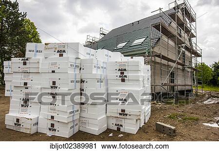 Stock Image - "New construction of a single-family house, a stack of insulation material lying on the construction site". Fotosearch