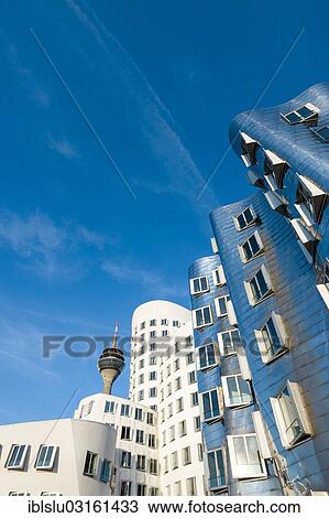 Stock Image - "New Zollhof office buildings designed by architect Frank O Gehry, Medienhafen, media harbour, Dusseldorf, Rhineland, North Rhine-Westphalia, Germany, Europe". Fotosearch