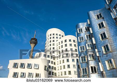 "New Zollhof office buildings designed by architect Frank O Gehry, Medienhafen, media harbour, Dusseldorf, Rhineland, North Rhine-Westphalia, Germany, Europe" View Large Photo Image Stock Photo - "New Zollhof office buildings designed by architect Frank O Gehry, Medienhafen, media harbour, Dusseldorf, Rhineland, North Rhine-Westphalia, Germany, Europe". Fotosearch