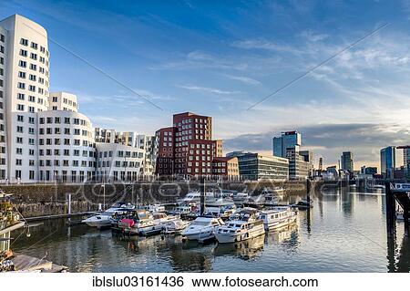 "New Zollhof office buildings designed by architect Frank O Gehry, Medienhafen, media harbour, Dusseldorf, Rhineland, North Rhine-Westphalia, Germany, Europe" View Large Photo Image Stock Photograph - "New Zollhof office buildings designed by architect Frank O Gehry, Medienhafen, media harbour, Dusseldorf, Rhineland, North Rhine-Westphalia, Germany, Europe". Fotosearch