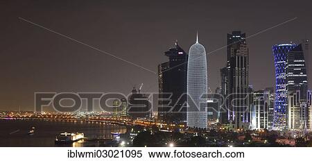 "Night scene, Corniche waterfront promenade and skyline of Doha with Al Bidda Tower, World Trade Center, Palm Tower 1 and 2, Burj Qatar Tower with silver illumination, Tornado Tower, Doha Corniche, Doha, Doha, Qatar, Asia" View Large Photo Image Stock Photography - "Night scene, Corniche waterfront promenade and skyline of Doha with Al Bidda Tower, World Trade Center, Palm Tower 1 and 2, Burj Qatar Tower with silver illumination, Tornado Tower, Doha Corniche, Doha, Doha, Qatar, Asia". Fotosearch