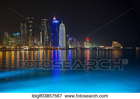 Stock Photo - "Night scene of the skyline of Doha with Al Bidda Tower, World Trade Center, Palm Tower 1 and 2, Burj Qatar Tower, Doha Corniche, Doha, Qatar, Asia". Fotosearch