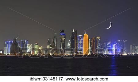 "Night skyline of Doha with the Al Bidda Tower, Palm Tower 1 and 2, the World Trade Center, Tornado Tower, Burj Qatar Tower, golden illumination, Al Fardan Tower Residences, Doha Bank Tower, moon, composite, Doha, Doha, Qatar, Asia" View Large Photo Image Stock Photo - "Night skyline of Doha with the Al Bidda Tower, Palm Tower 1 and 2, the World Trade Center, Tornado Tower, Burj Qatar Tower, golden illumination, Al Fardan Tower Residences, Doha Bank Tower, moon, composite, Doha, Doha, Qatar, Asia". Fotosearch