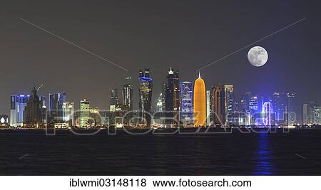 "Night skyline of Doha with the Al Bidda Tower, Palm Tower 1 and 2, the World Trade Center, Tornado Tower, Burj Qatar Tower, golden illumination, Al Fardan Tower Residences, Doha Bank Tower, moon, composite, Doha, Doha, Qatar, Asia" View Large Photo Image Stock Photo - "Night skyline of Doha with the Al Bidda Tower, Palm Tower 1 and 2, the World Trade Center, Tornado Tower, Burj Qatar Tower, golden illumination, Al Fardan Tower Residences, Doha Bank Tower, moon, composite, Doha, Doha, Qatar, Asia". Fotosearch