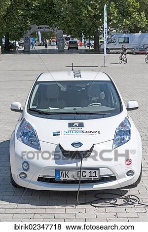 Stock Photo - "Nissan's electric vehicle having its batteries charged before the prologue of the e-miglia 2012 from Munich to St. Moritz, Munich, Bavaria, Germany, Europe". Fotosearch