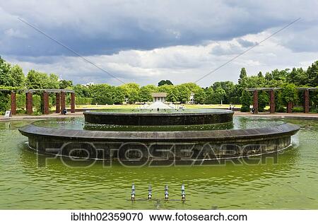 Stock Image - "Nordpark garden, water basins and a fountain at the park entrance, Duesseldorf, North Rhine-Westphalia, Germany, Europe". Fotosearch