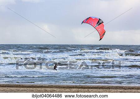 "North Sea beach, stormy sea during an autumn storm, kite surfer, De Haan, Flanders, Belgium, Europe" View Large Photo Image Stock Photograph - "North Sea beach, stormy sea during an autumn storm, kite surfer, De Haan, Flanders, Belgium, Europe". Fotosearch