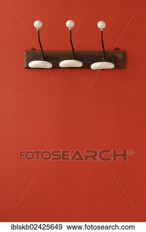 Nostalgic coat hooks on red wall View Large Photo Image Stock Photo - Nostalgic coat hooks on red wall. Fotosearch