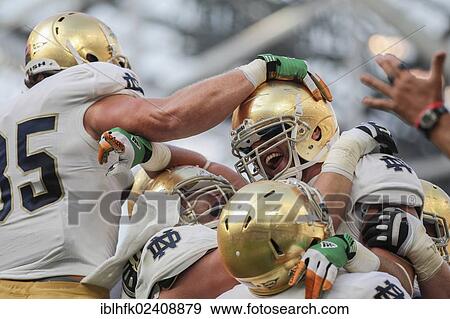Stock Photo - "Notre Dame players celebrate a touchdown during the NCAA football game between the Navy and the Notre Dame on September 1, 2012 in Dublin, Ireland, Europe". Fotosearch