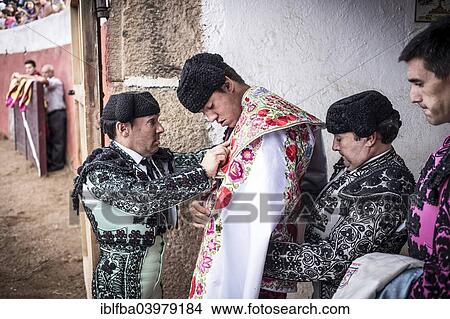 Picture - "Novillero, young fighter, being dressed before a bullfight, Barco de Avila, Avila, Castile and Leon, Spain, Europe". Fotosearch